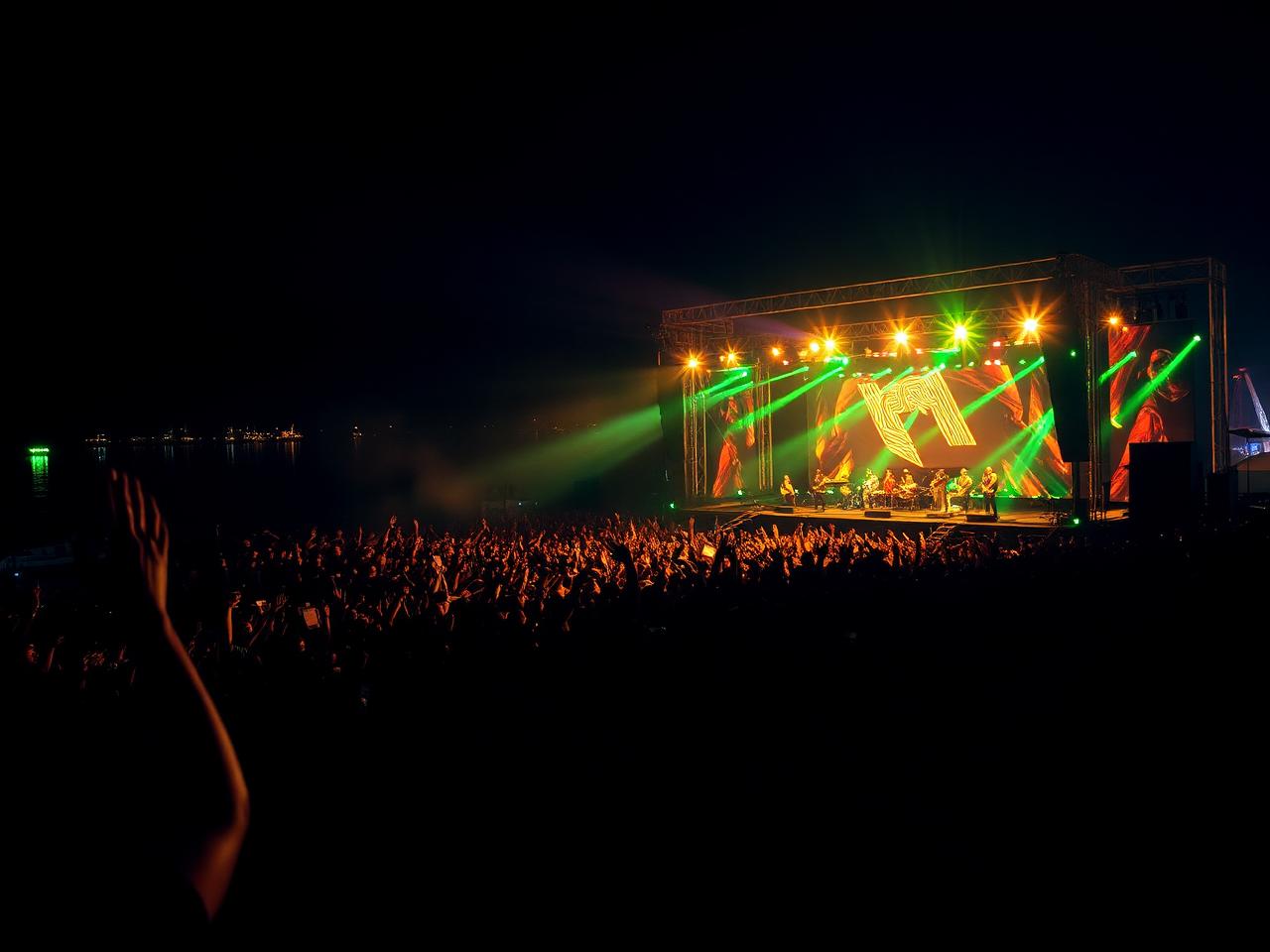 Afrobeats concert crowd at a waterfront stage